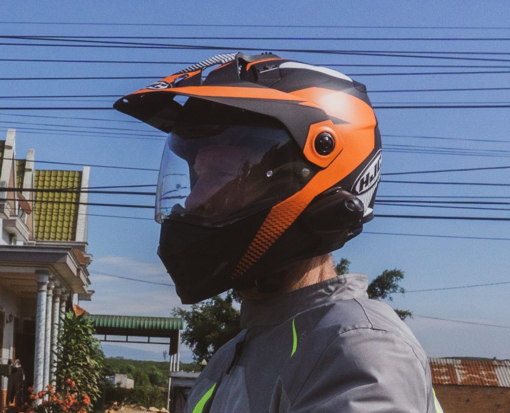 An adventure rider wearing his motorbike helmet in Vietnam